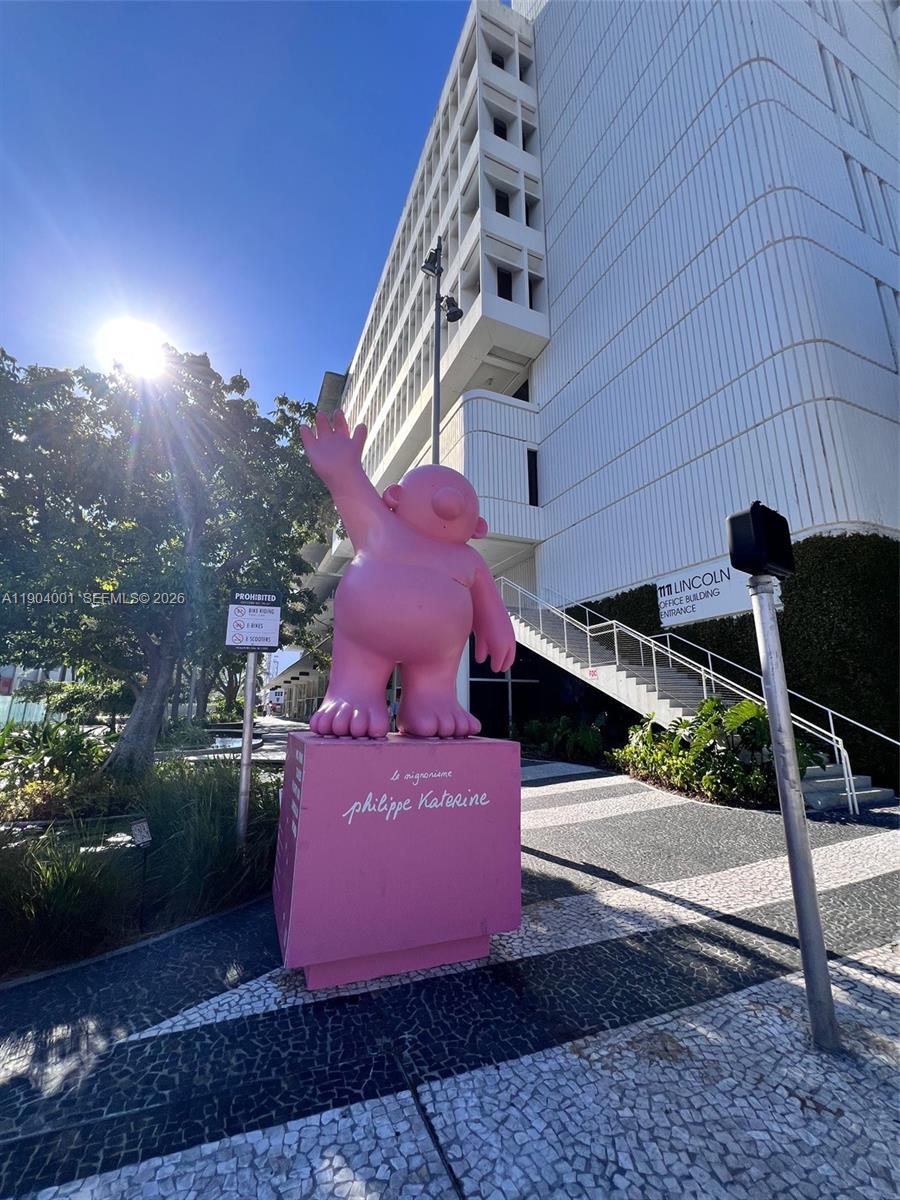 1300 Lincoln Road, Unit D304 Miami Beach, FL 33139 - Photo 9 of 25 a view of a patio with table and chairs with wooden floor and fence