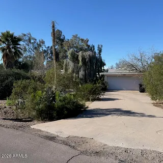 a view of a house with a yard and tree s