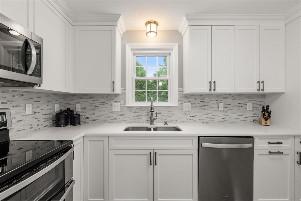 37 Benjamin Road Marlborough, MA 01752 - Photo 18 of 39 a kitchen with stainless steel appliances granite countertop a sink stove and microwave