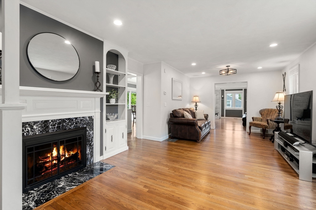 37 Benjamin Road Marlborough, MA 01752 - Photo 9 of 39 a living room with furniture a fireplace a flat screen tv and kitchen view