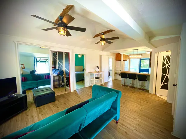 a view of a dining room with furniture and a chandelier