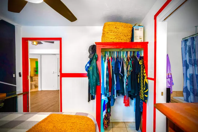 a bathroom with a toilet sink vanity granite and mirror