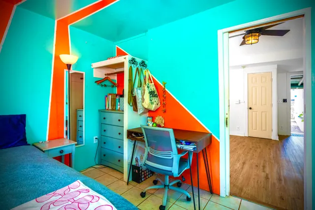 a bedroom with 2 bed and a window