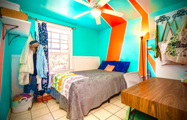 a bedroom with a bed and a window