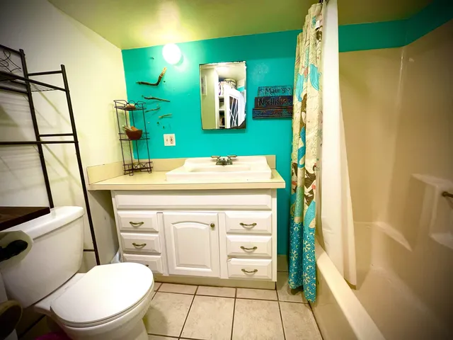 a room with a bed and a chandelier