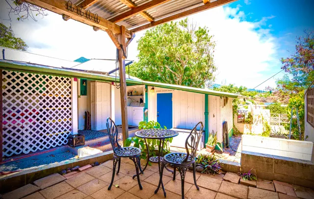 a view of a hallway with wooden floor and dining room