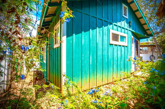 a view of a house with wooden fence