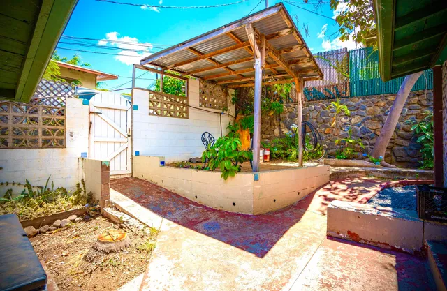 a backyard of a house with table and chairs