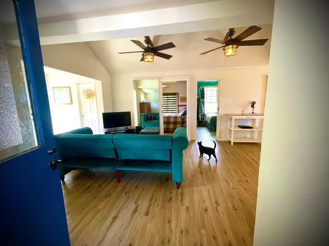 a living room with furniture and a wooden floor