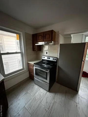 a kitchen with stainless steel appliances granite countertop a sink and a stove