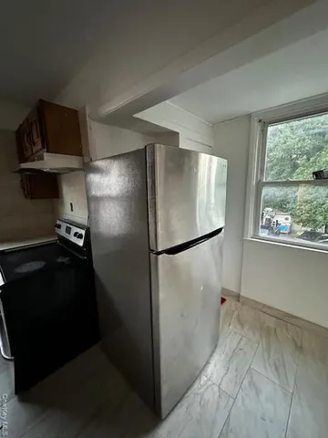 a stove top oven sitting inside of a kitchen