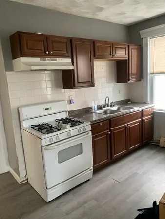 a kitchen with stainless steel appliances a stove a sink and a microwave