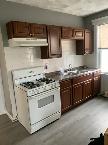 a kitchen with stainless steel appliances a stove a sink and a microwave
