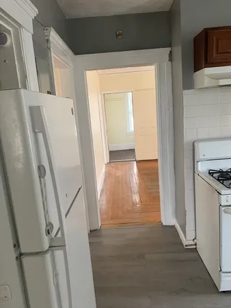 a view of a kitchen from a hallway