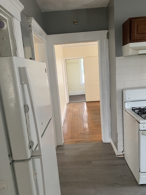19 Barney Avenue, Unit 1 Pawtucket, RI 02860 - Photo 4 of 7 a view of a kitchen from a hallway