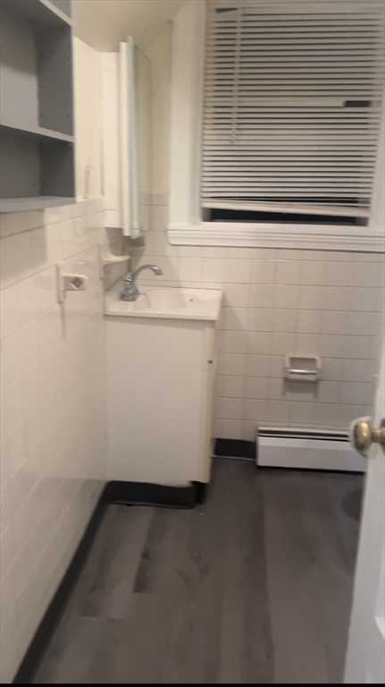 19 Barney Avenue, Unit 1 Pawtucket, RI 02860 - Photo 6 of 7 a bathroom with a sink a mirror and a toilet