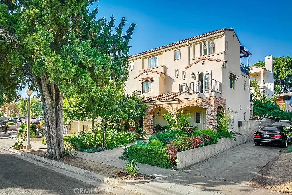 a front view of a house with a yard and a garage