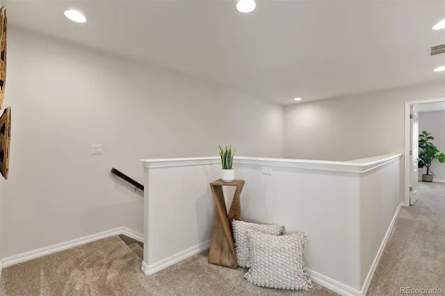 a bedroom with a bed and a lamp