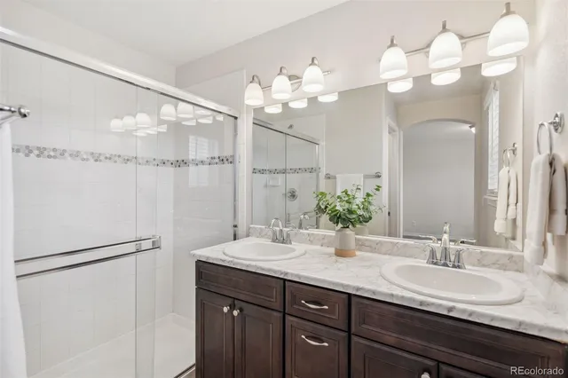 a bathroom with a sink vanity and a mirror