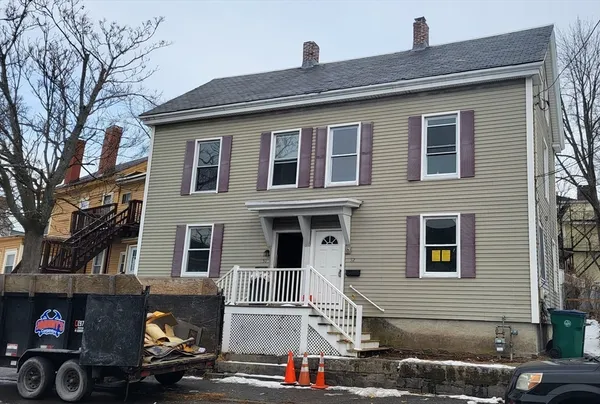 a front view of a house with parking