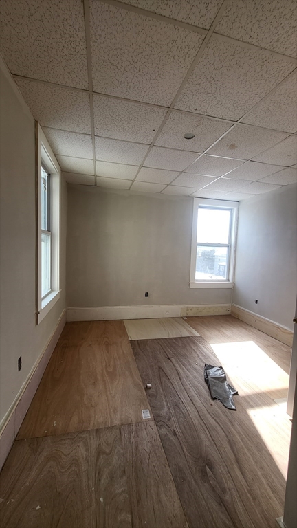 52 Willow Street, Unit 52 Lowell, MA 01852 - Photo 11 of 16 a view of empty room with wooden floor and fan
