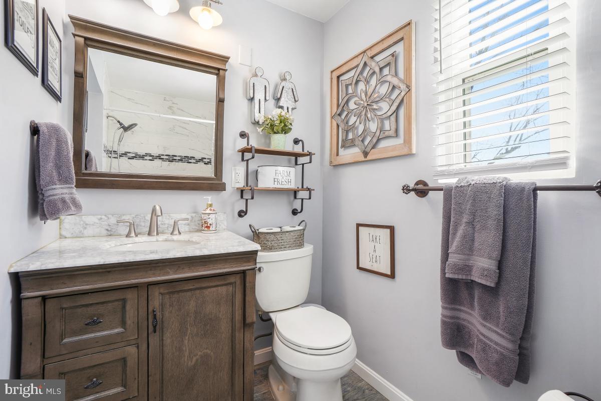 6703 Anders Terrace Springfield, VA 22151 - Photo 16 of 33 a bathroom with a toilet sink and mirror