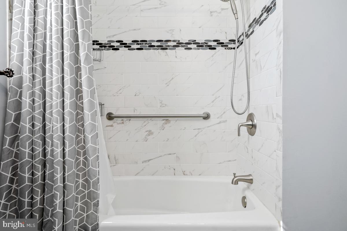 6703 Anders Terrace Springfield, VA 22151 - Photo 17 of 33 a bathroom with a shower curtain and a bathtub
