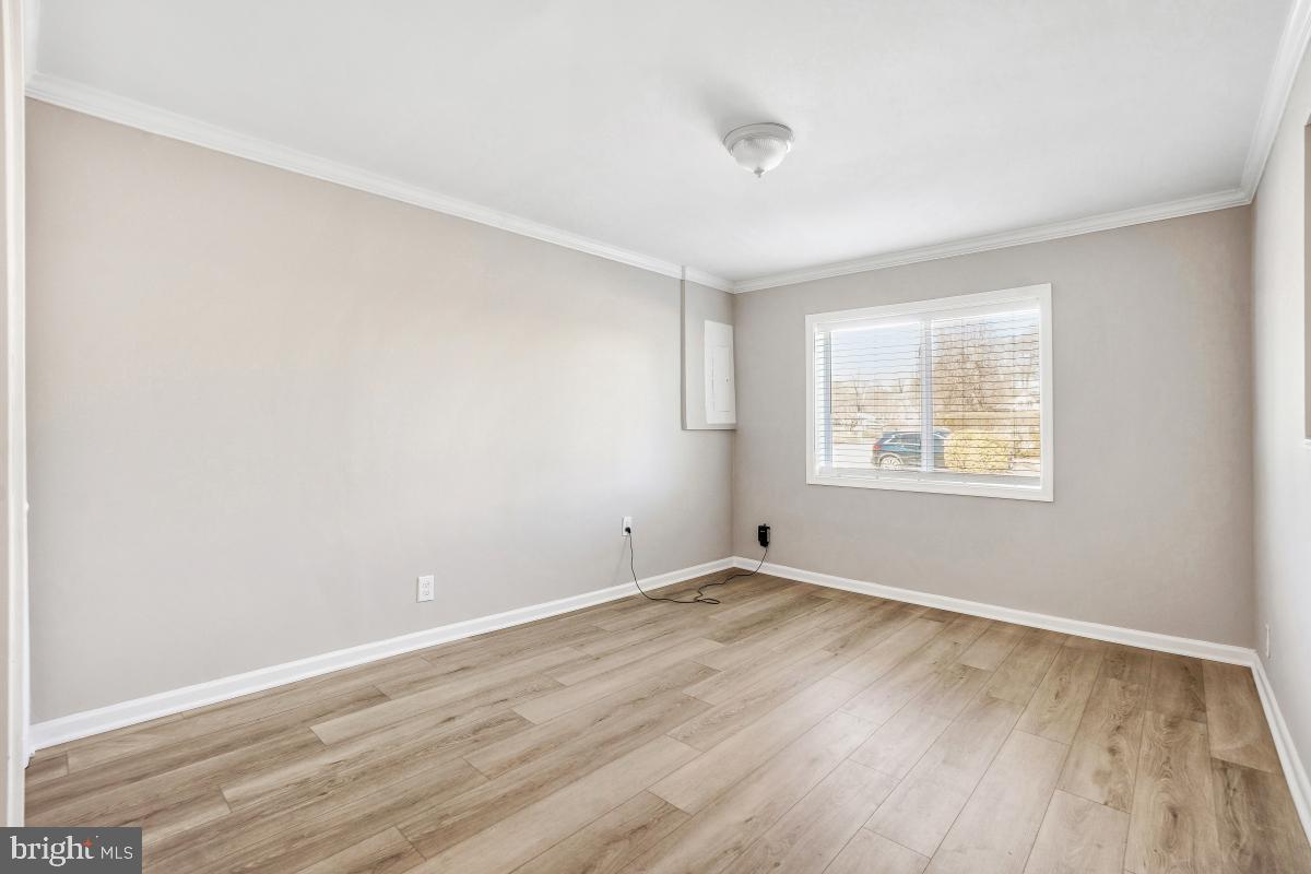 6703 Anders Terrace Springfield, VA 22151 - Photo 24 of 33 an empty room with wooden floor and windows