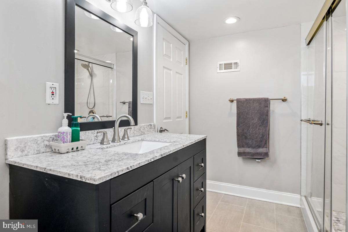 6703 Anders Terrace Springfield, VA 22151 - Photo 26 of 33 a bathroom with a granite countertop sink and a mirror