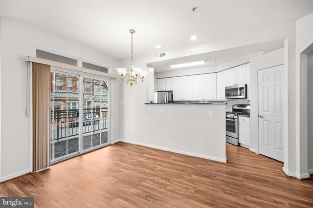 a kitchen with stainless steel appliances granite countertop a stove microwave and refrigerator