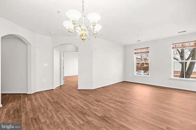 a kitchen with a sink stove refrigerator and cabinets