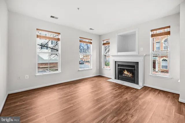 a kitchen with granite countertop a sink cabinets and stainless steel appliances