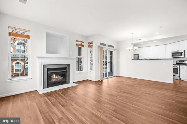 a kitchen with granite countertop a sink stove top oven and microwave