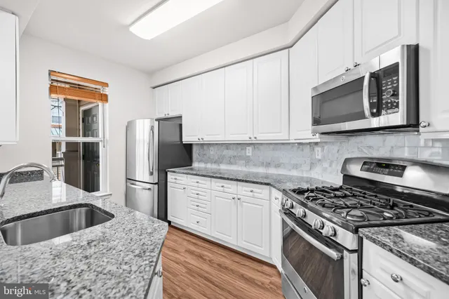 a bathroom with a double vanity sink toilet mirror and bathtub