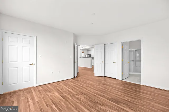 a view of a room with wooden floor