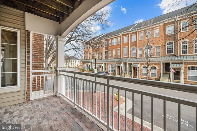 a view of a house with a big yard and large trees