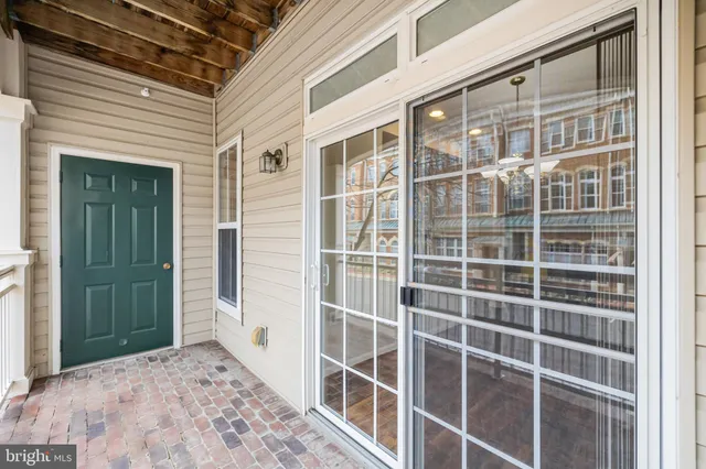 a front view of a house with a garden and trees