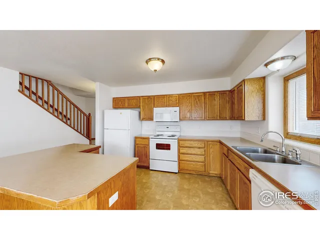 a kitchen with stainless steel appliances kitchen island sink stove and cabinets