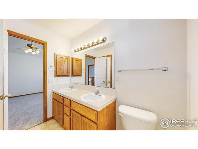 a bathroom with a sink toilet a mirror and vanity