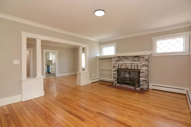 wooden floor in an empty room with a window