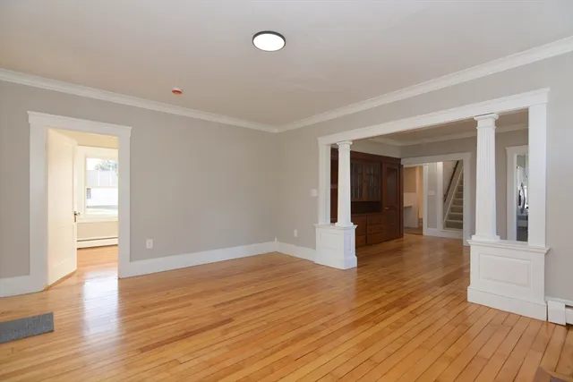 wooden floor in an empty room with a window
