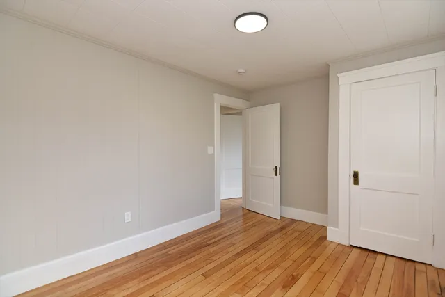a view of an empty room and wooden floor
