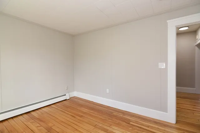 a view of an empty room and wooden floor