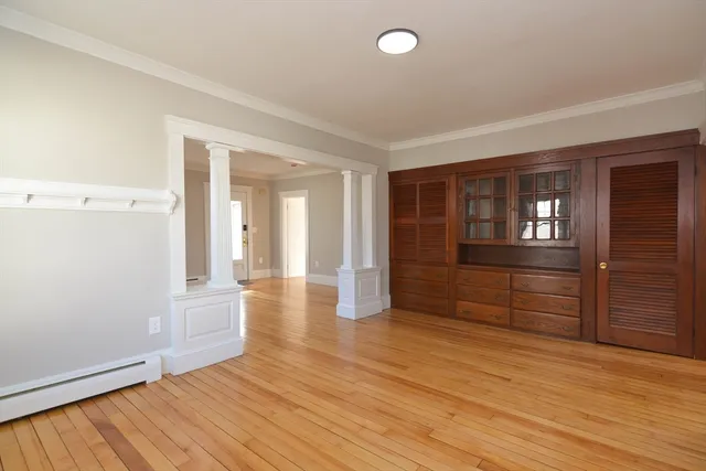 wooden floor in an empty room with a window