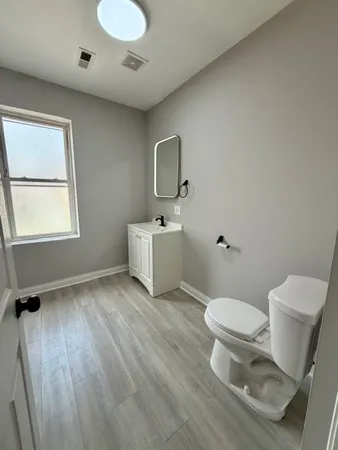 a bathroom with a toilet sink and mirror