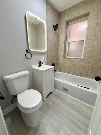 a bathroom with a toilet a sink and bathtub