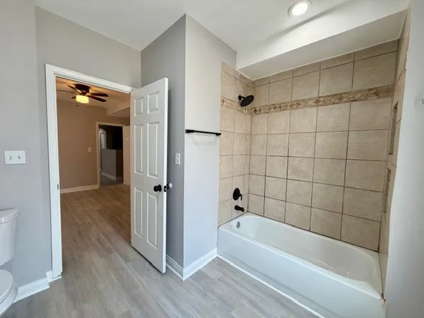 a bathroom with a bathtub and a shower