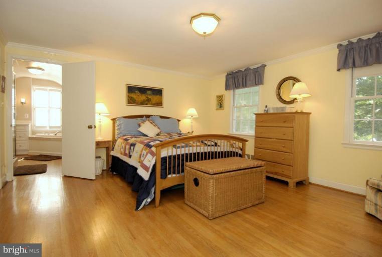 5618 Jordan Road Bethesda, MD 20816 - Photo 14 of 30 a bedroom with a bed and wooden floor