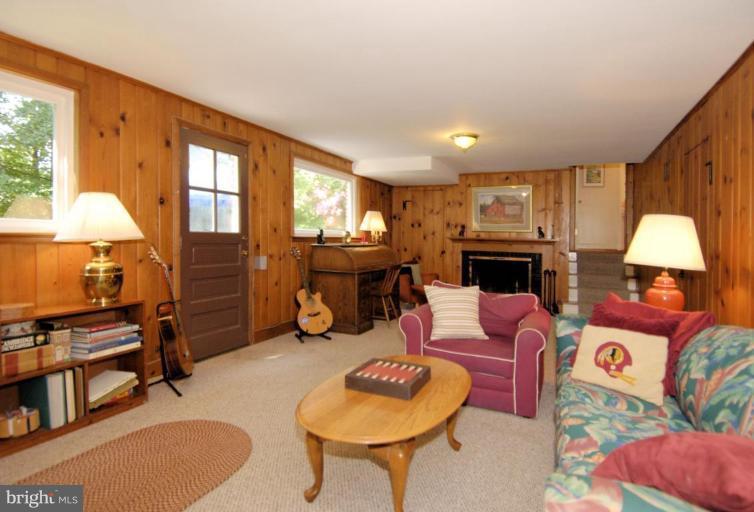 5618 Jordan Road Bethesda, MD 20816 - Photo 22 of 30 a living room with furniture a fireplace and a window