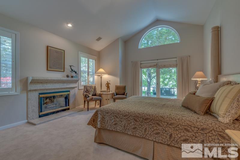 4275 Bitteroot Road Reno, NV 89519 - Photo 15 of 39 a bedroom with a bed and a fireplace